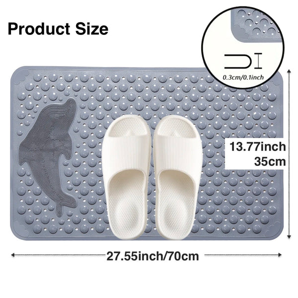 A gray rectangular non-slip bath mat with a dolphin shape molded into the surface and two white flip-flops displayed on it.
