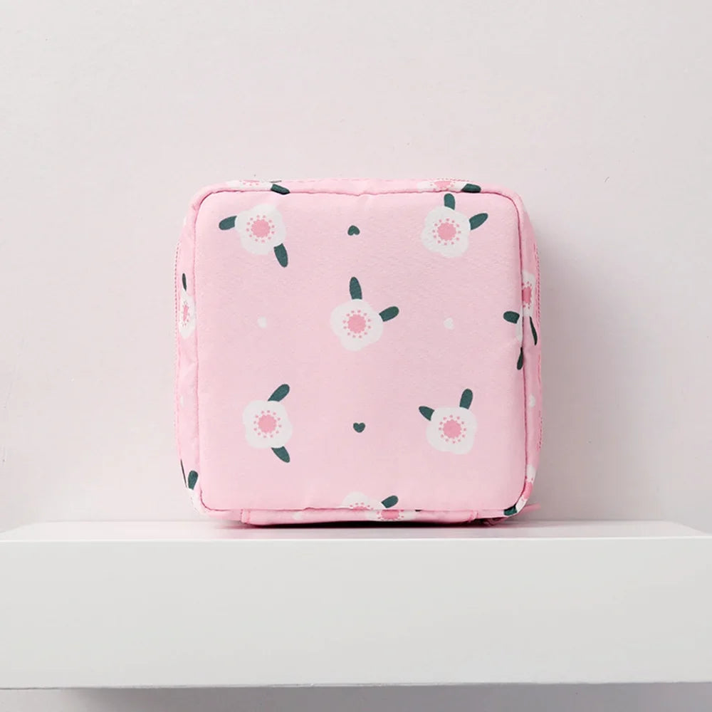 Pink floral nylon sanitary pad storage pouch with white and green flower patterns