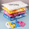A stack of colorful reusable transparent shower caps in various shades of yellow, pink, and blue.