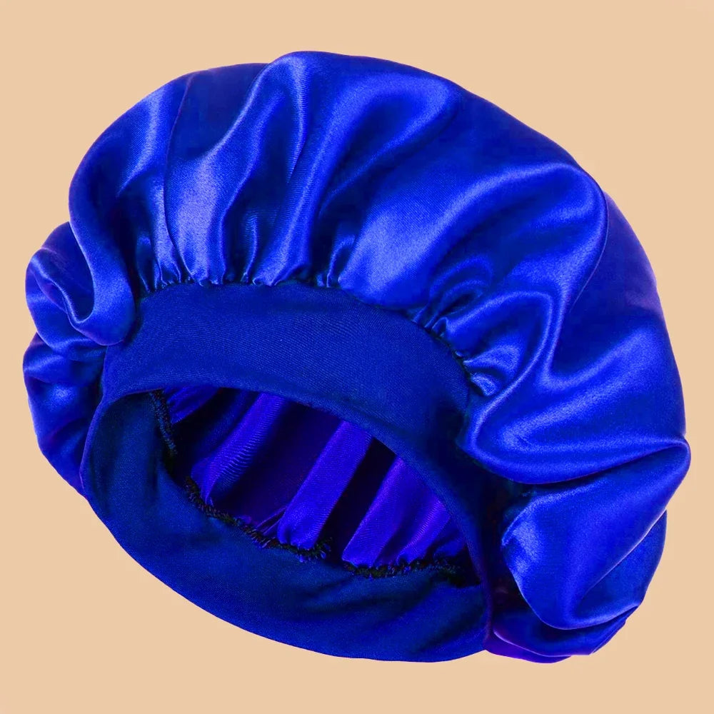 A vibrant royal blue satin wide brim shower cap folded and displayed against a light background.