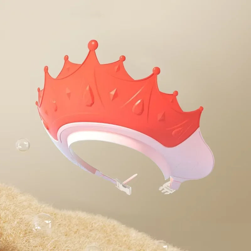 An adjustable baby bath shampoo shield cap in orange and white is shown against a light background.