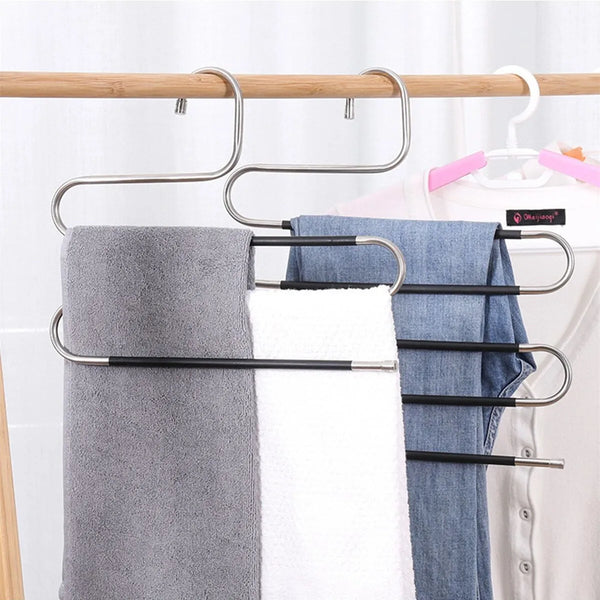 Stainless steel S-shaped drying rack hanger holding gray and white towels on a rack.