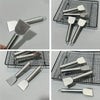 A collection of stainless steel multi-purpose scrapers and spatulas shown on a black wire rack.