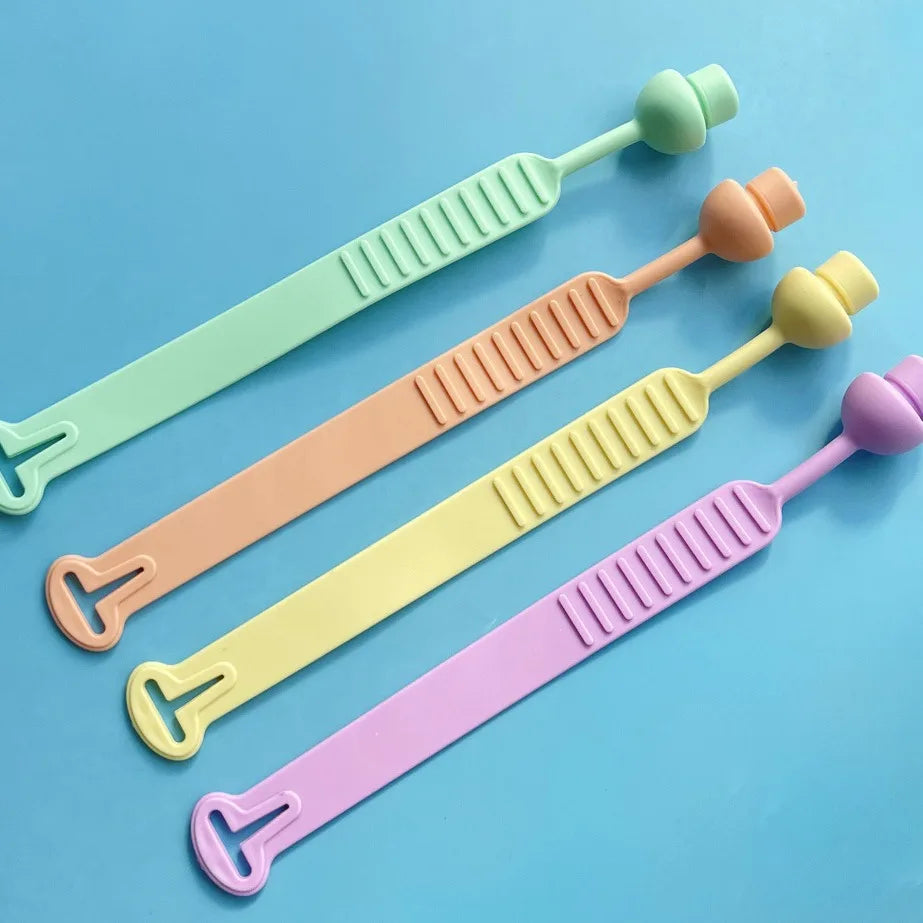 A set of silicone toilet seat lifters in pastel colors including mint green, peach, yellow, and purple.
