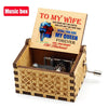 An antique wooden hand crank music box with an engraved lid featuring a poem to his wife