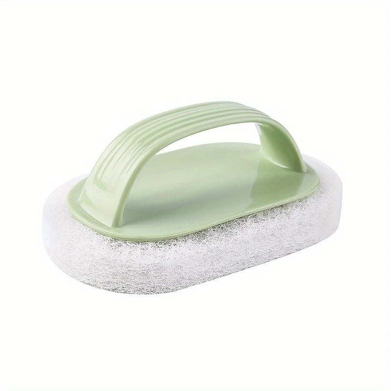 A light green magic sponge scrubber with an ergonomic handle resting on a white foam pad.