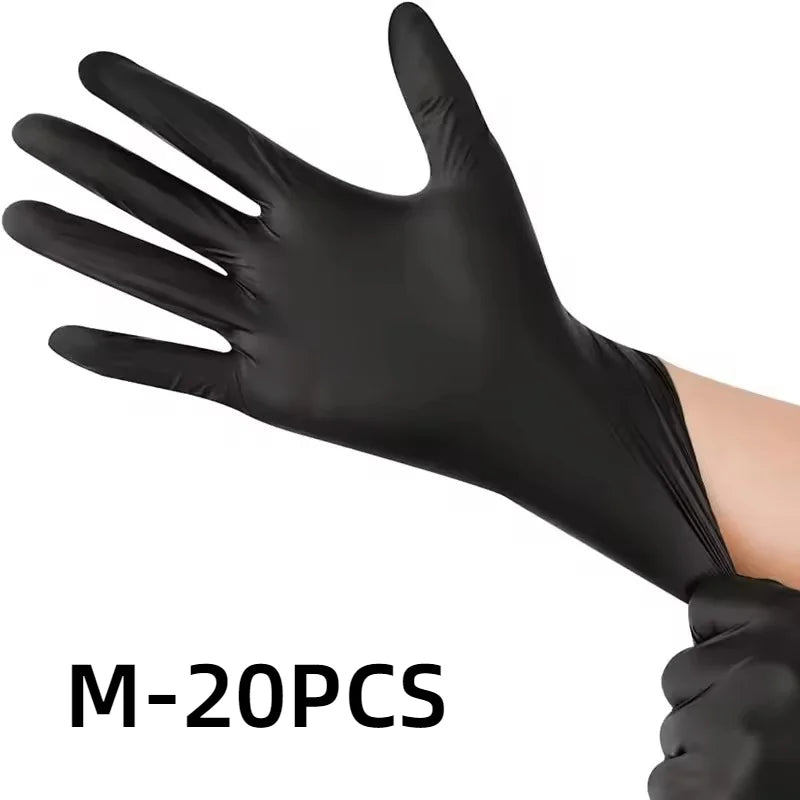 A hand wearing a black disposable nitrile glove is shown against a white background.