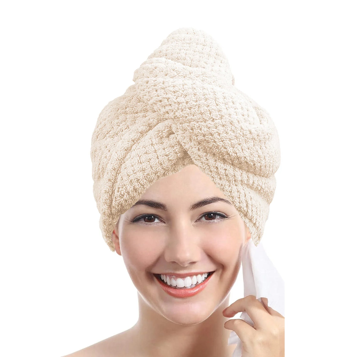 A woman is smiling while wearing a beige microfiber hair drying towel wrap on her head.