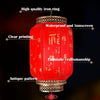 A red Chinese lantern with clear printing, an antique pattern, and a gold knot pendant.