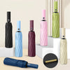 A collection of heavy-duty automatic folding umbrellas in various colors including black, blue, pink, and green.