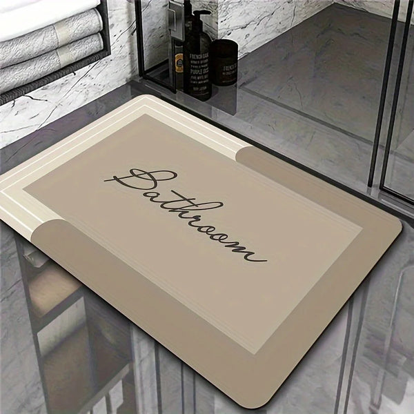 A rectangular mat with the word Bathroom written on it is displayed on a glass surface.