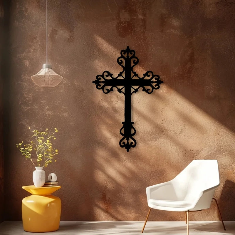 A black metal cross wall art decor is mounted on a textured brown wall, with a yellow vase and a white chair visible below.