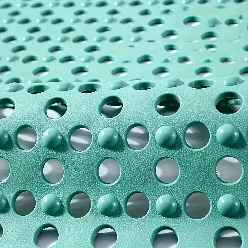 Primer plano de una alfombra de ducha de PVC verde azulado antideslizante con patrón de rejilla de orificios circulares de dr