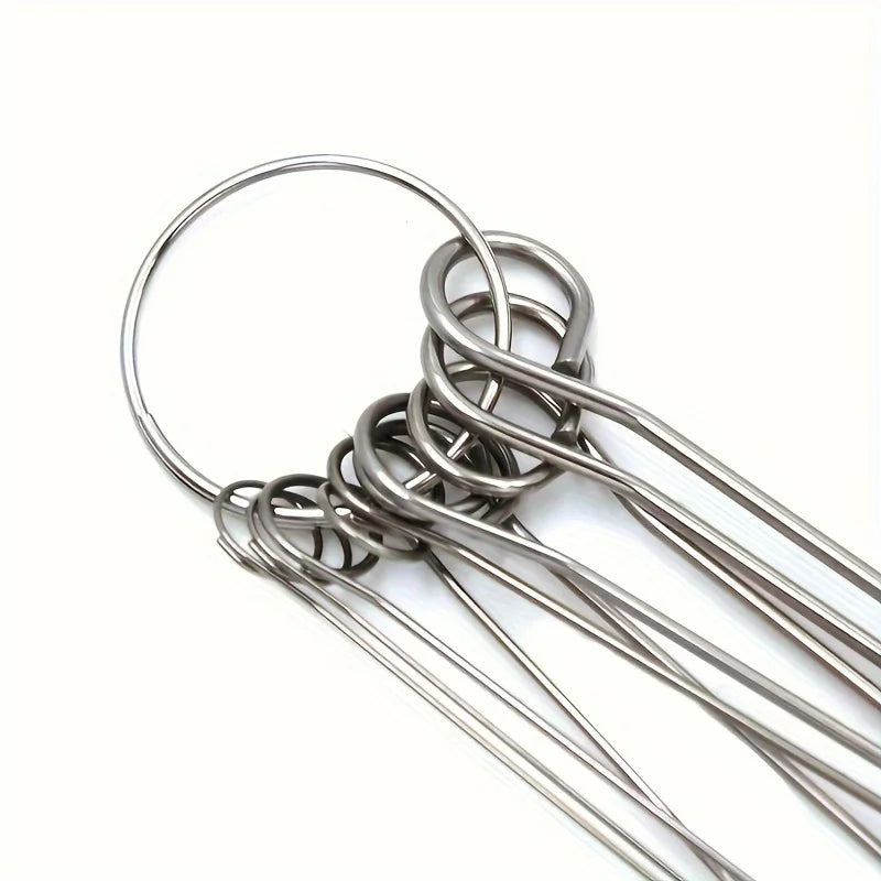 A set of stainless steel shower head cleaning brushes coiled together.