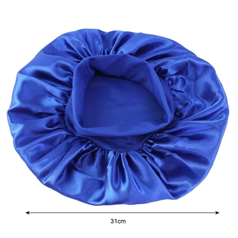 A royal blue satin wide-brim sleeping bonnet for hair care, shown flat.