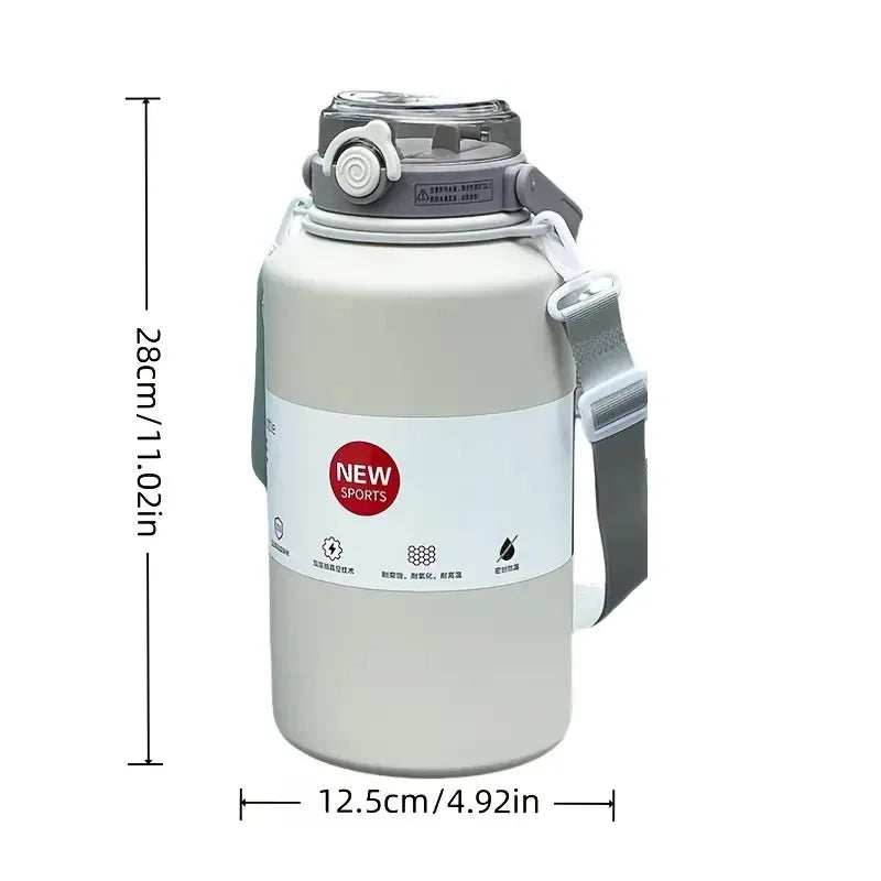 A large stainless steel insulated tumbler with a lid, handle, and straw, shown in a light beige color.