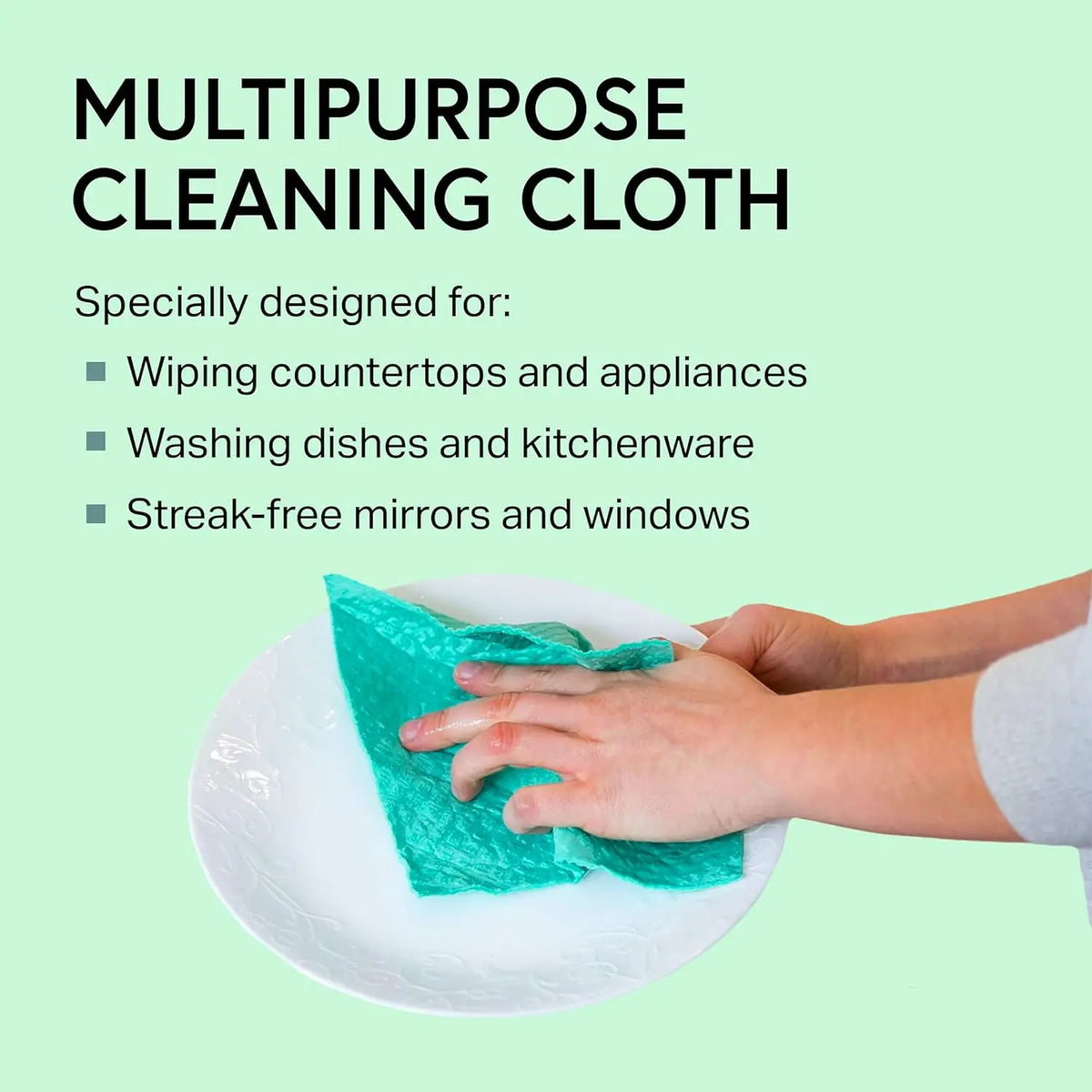 A hand is using a teal cleaning cloth to wipe a white plate.