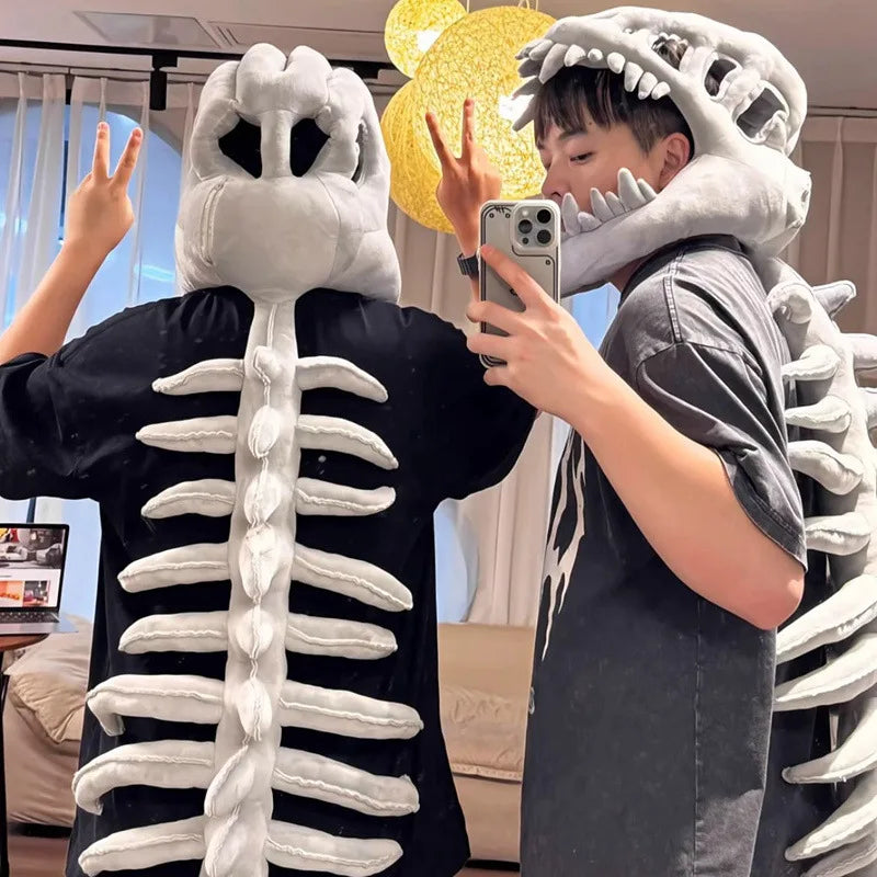 A person wearing a dinosaur skeleton costume with a large white rib cage and skull structure.