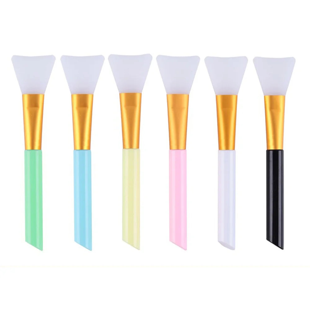 A set of six silicone facial mask brushes in various pastel colors, featuring gold and white handles.