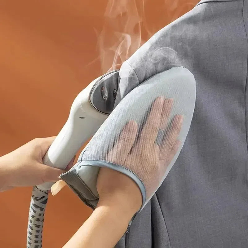 A hand is holding a handheld ironing board with a protective glove and iron, demonstrating the product.