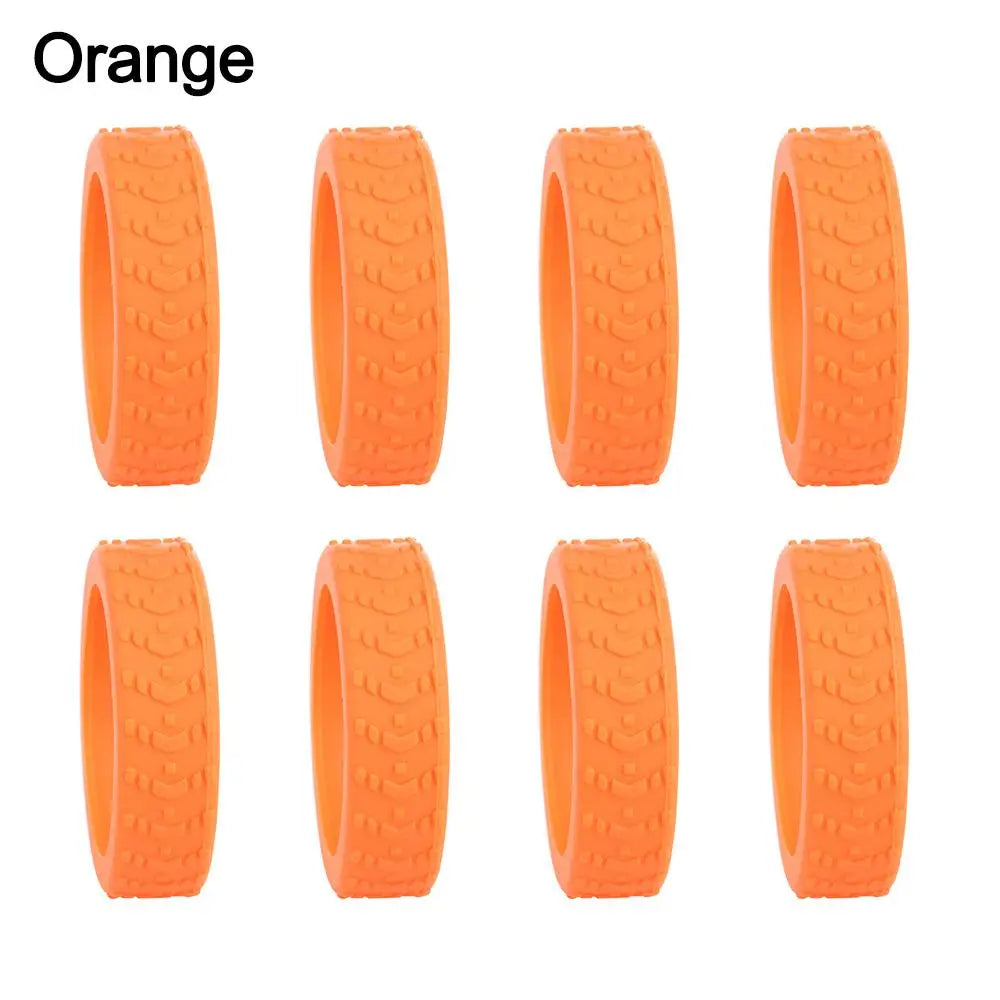 Eight orange silicone protectors for luggage wheels.