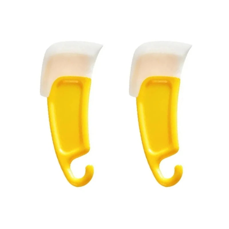 A pair of yellow silicone kitchen scrapers with white handles.