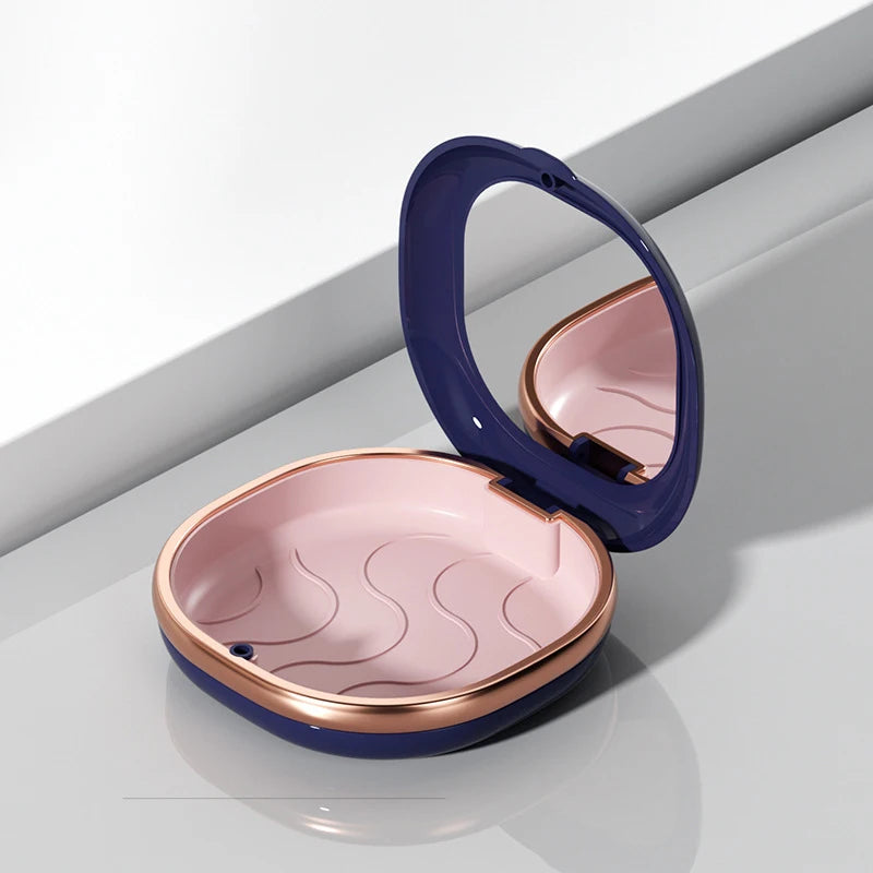 A compact dental retainer case in purple and rose gold with a hinged lid and built-in mirror.