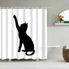 Black silhouette of a cat standing on its hind legs against a white shower curtain background