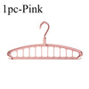 A single pink foldable multi-hole space-saving laundry drying rack.