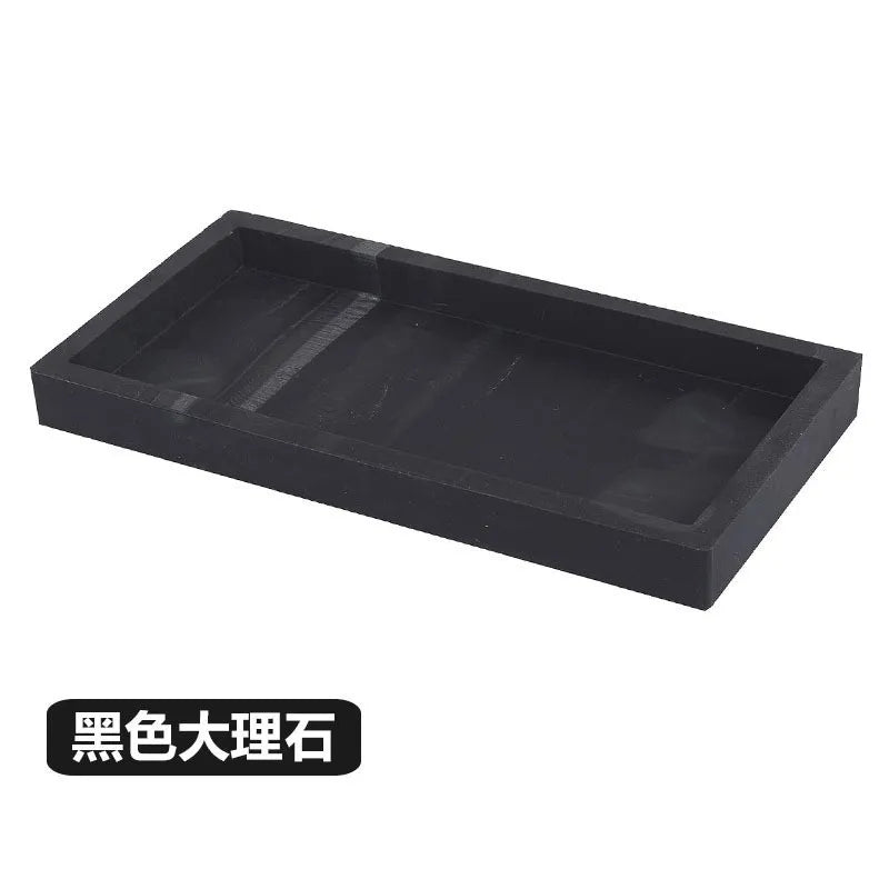 Black granite tray organizer set with a rectangular, slotted design.