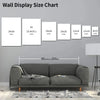 A chart showing various sizes of wall display art in inches, displayed above a gray sofa.
