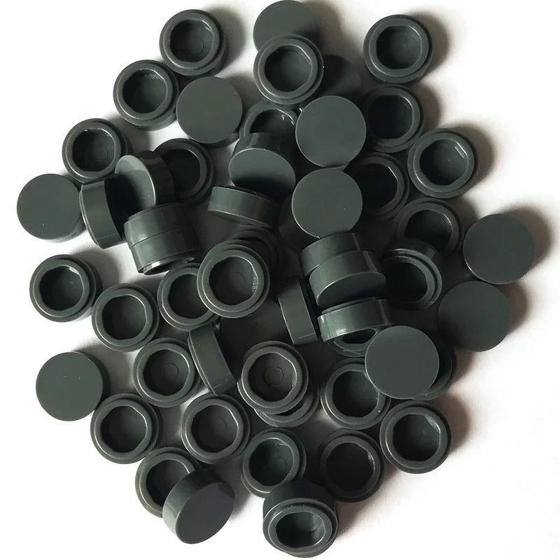 A pile of round, dark gray building blocks for DIY projects.