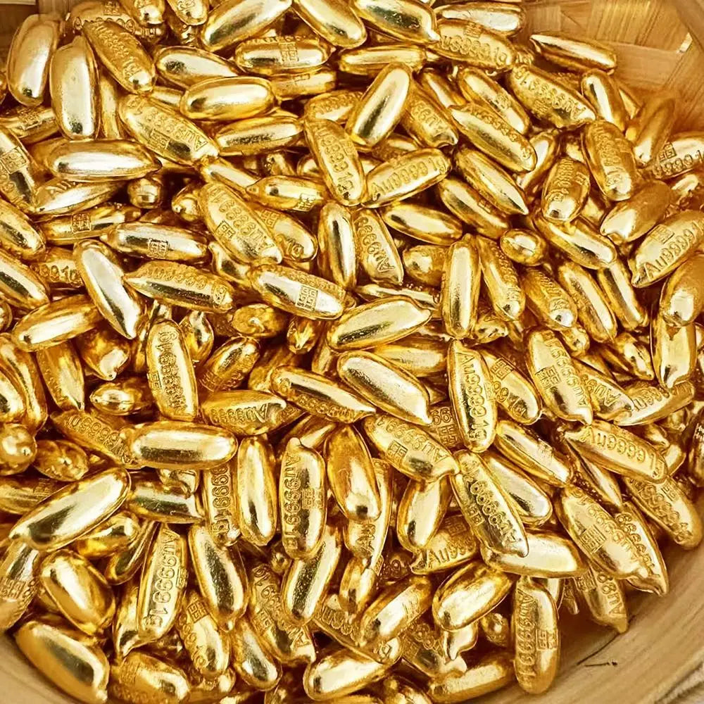 A close-up view of numerous small, elongated gold bar decorative ornaments.