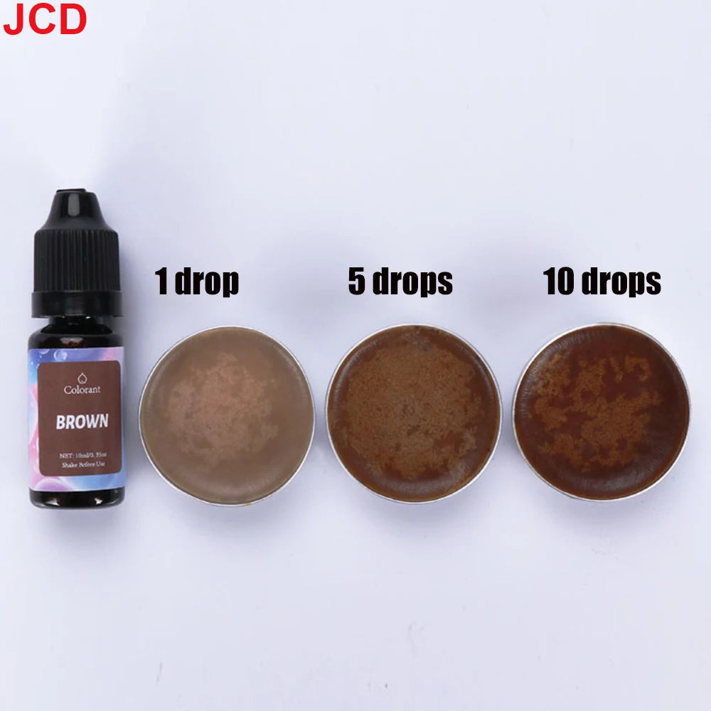 A bottle of brown liquid candle dye with dropper, next to three circular discs showing 1, 5, and 10 drops of the dye.