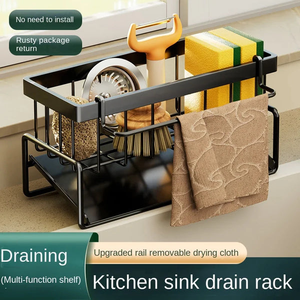 A black kitchen sink drain rack holds a yellow sponge and a beige cloth, designed for draining.