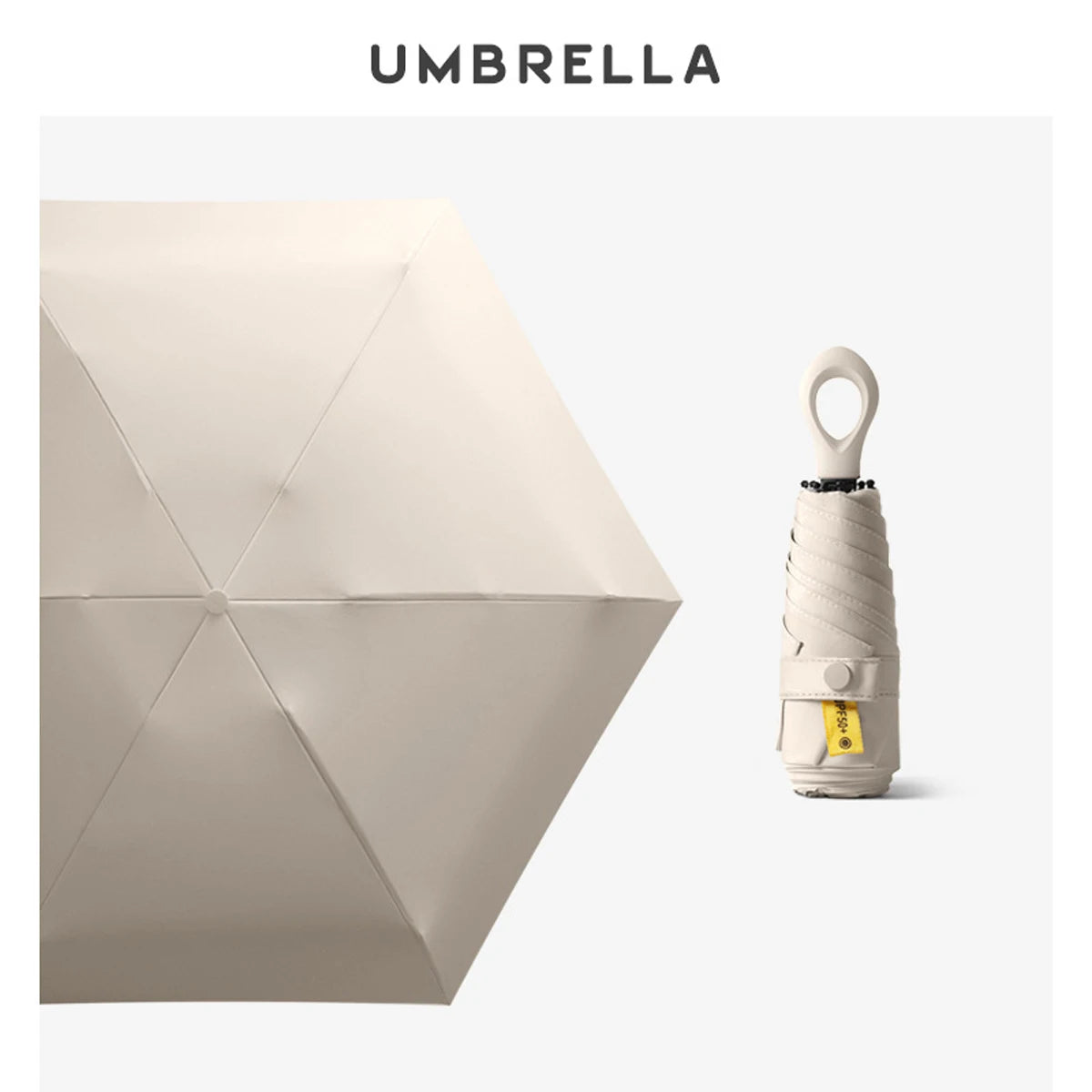 A beige compact mini umbrella with a rolled handle and yellow tag is shown against a white background.