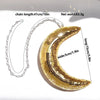 Gold glitter crescent moon necklace with silver chain, measuring 15cm long and 5cm wide.