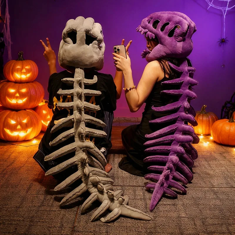 A person dressed in a realistic dinosaur skeleton costume, featuring a large purple rib cage and skull, posing indoors.