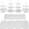 White plastic dessert stands with various tiers and plates for fruit and candy