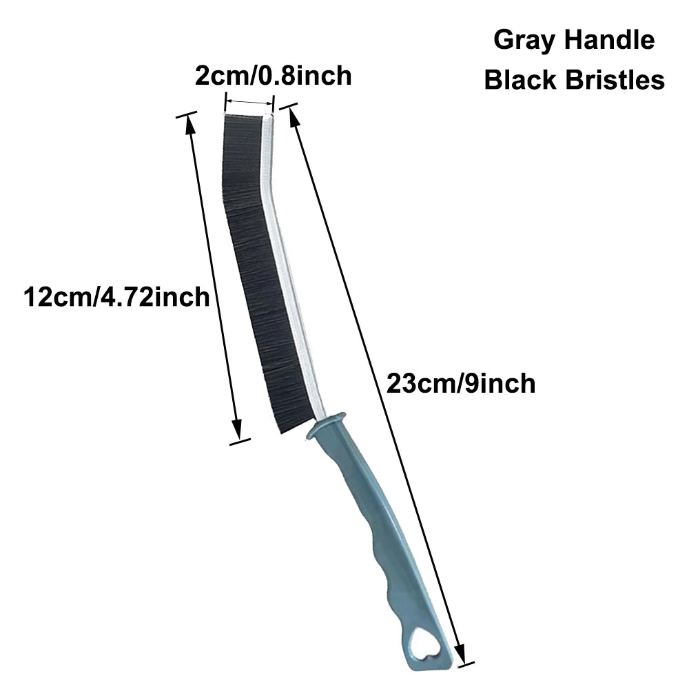 A long, narrow crevice cleaning brush with a gray handle and black bristles.