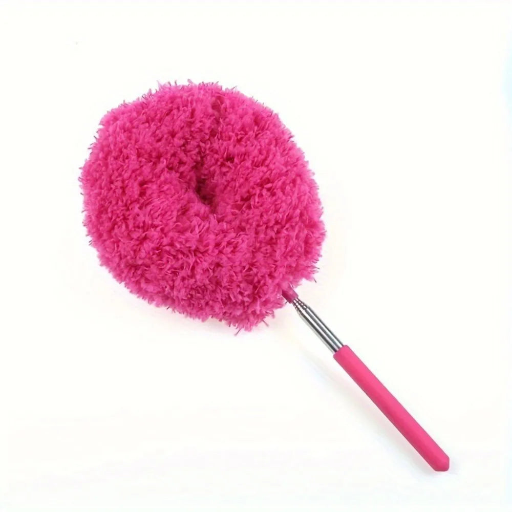 A bright pink, fluffy microfiber duster with a long handle used for cleaning.