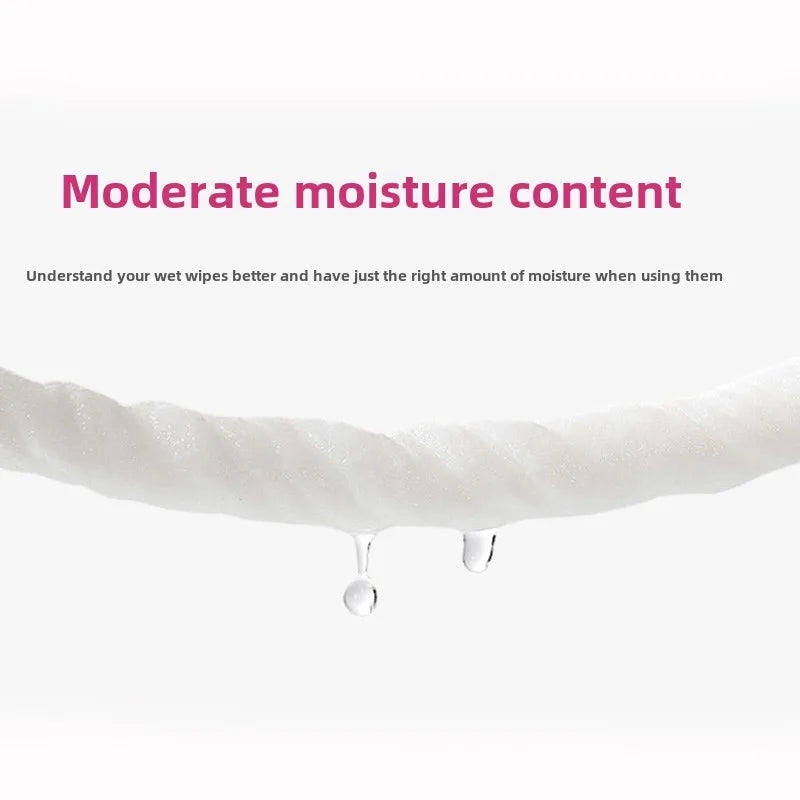 A close-up of white wipes with moisture dripping from the edge, demonstrating moderate moisture content.