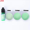 A dropper bottle of light green liquid candle dye with three circular samples showing 1, 5, and 10 drops.