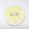 A reusable fruit shower cap with a yellow lemon slice design and the word lucky printed on it.