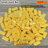 A pile of 100 small gold bars used as decorative ornaments.
