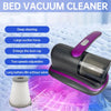 A black and purple handheld bed vacuum cleaner is shown with a dust cup and a cleaning head on a textured surface.
