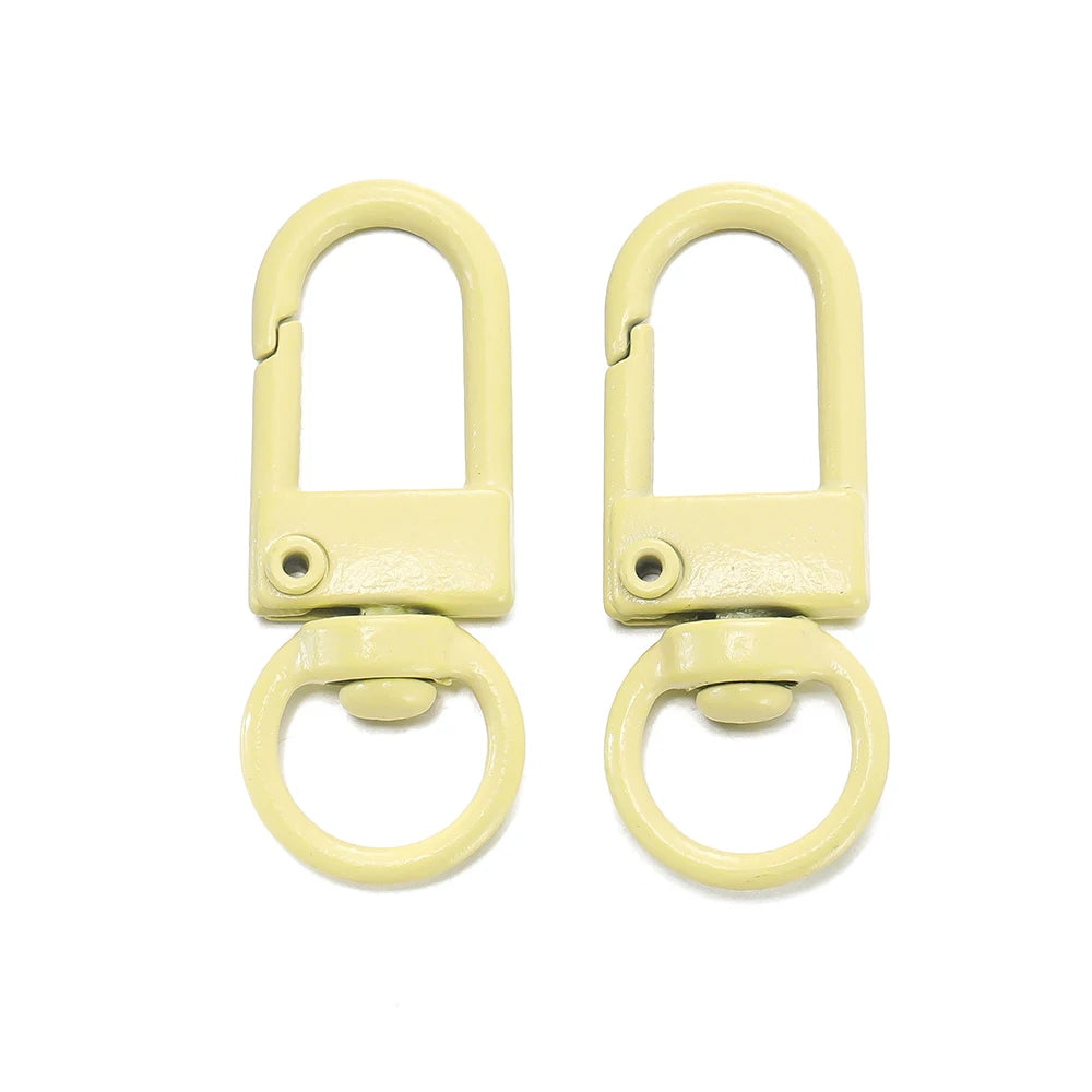 A pair of light yellow alloy snap lobster clasp hooks for jewelry making