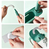 Hands demonstrate the adjustable over-sink dish rack organizer in green and white.