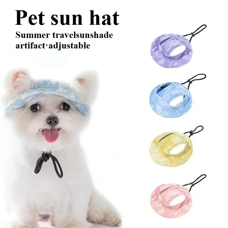 A small white dog wearing a pink sun hat for summer travel protection.
