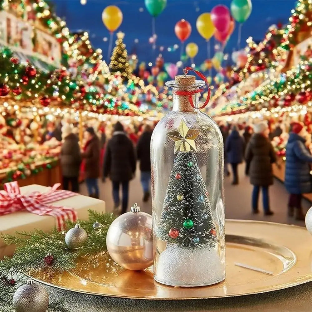 A glass bottle filled with glitter and a miniature Christmas tree is displayed on a gold plate amidst a festive holiday marke